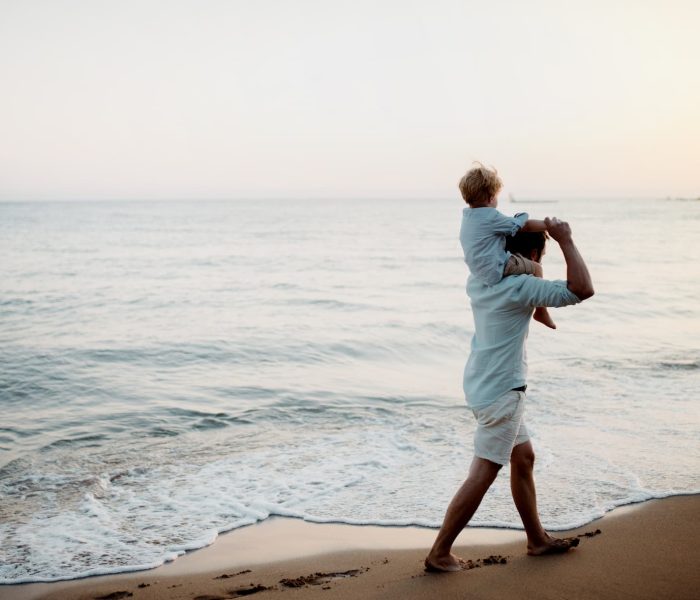 father-with-a-toddler-boy-walking-on-beach-on-summ-2023-11-27-05-27-27-utc